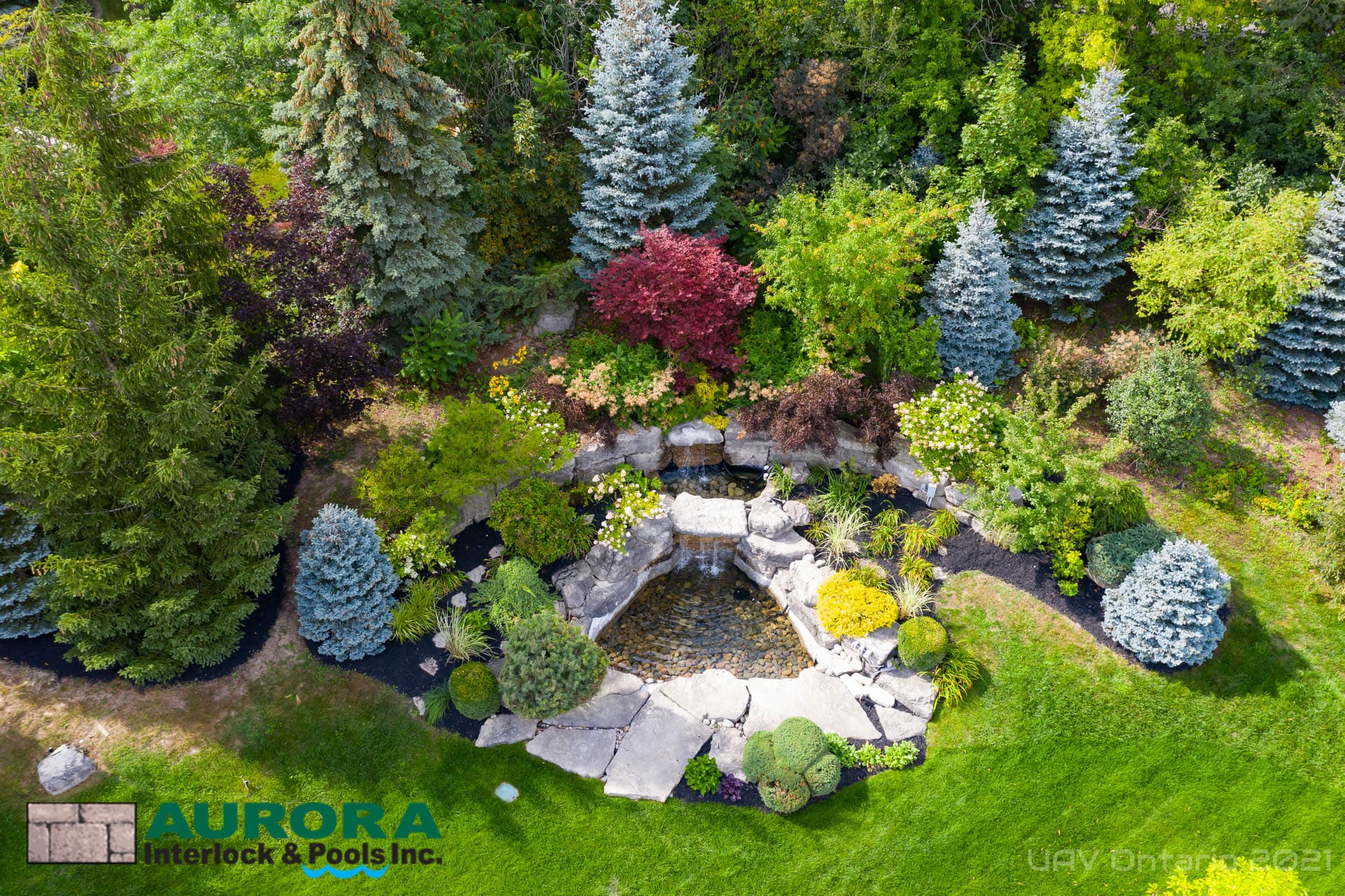 Landscaped garden with layered plantings and natural stone