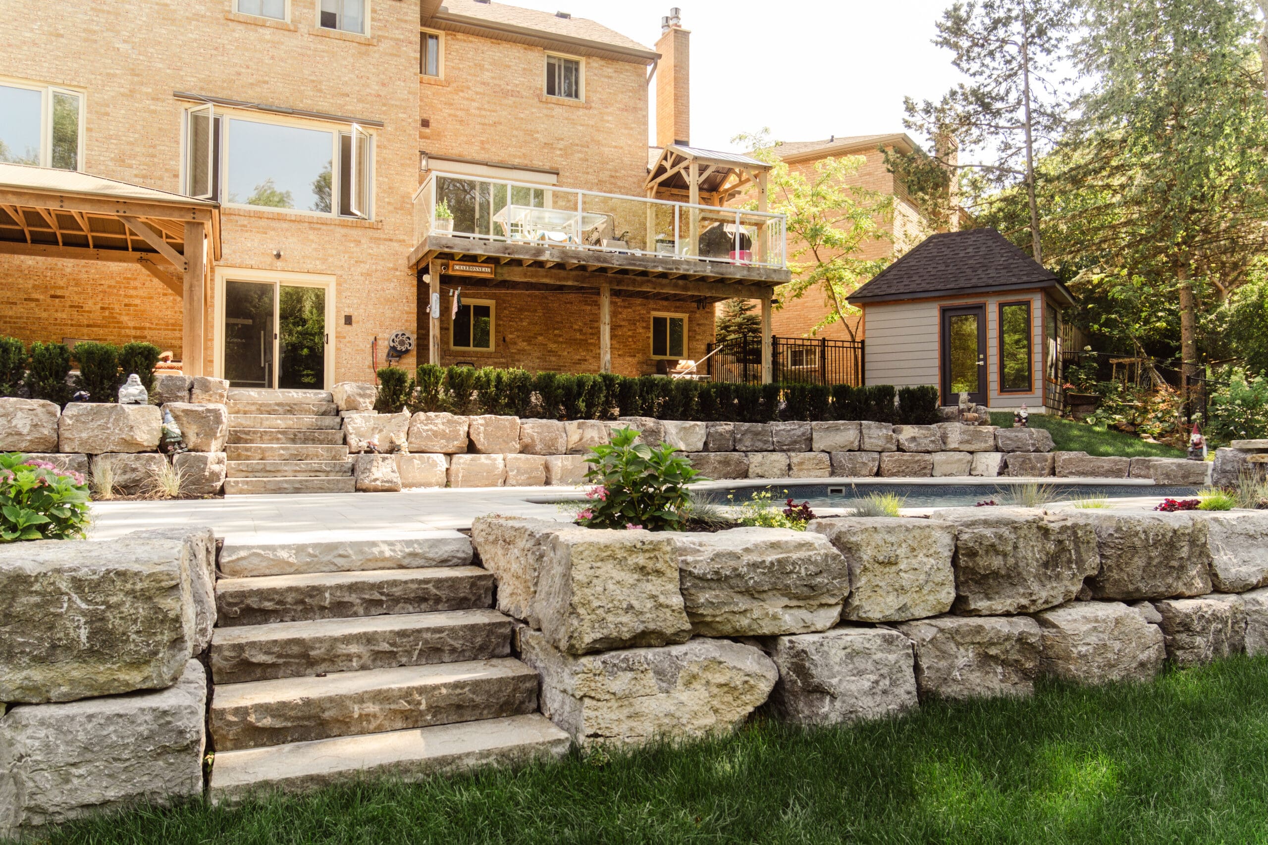 Armour stone retaining wall with natural stone steps
