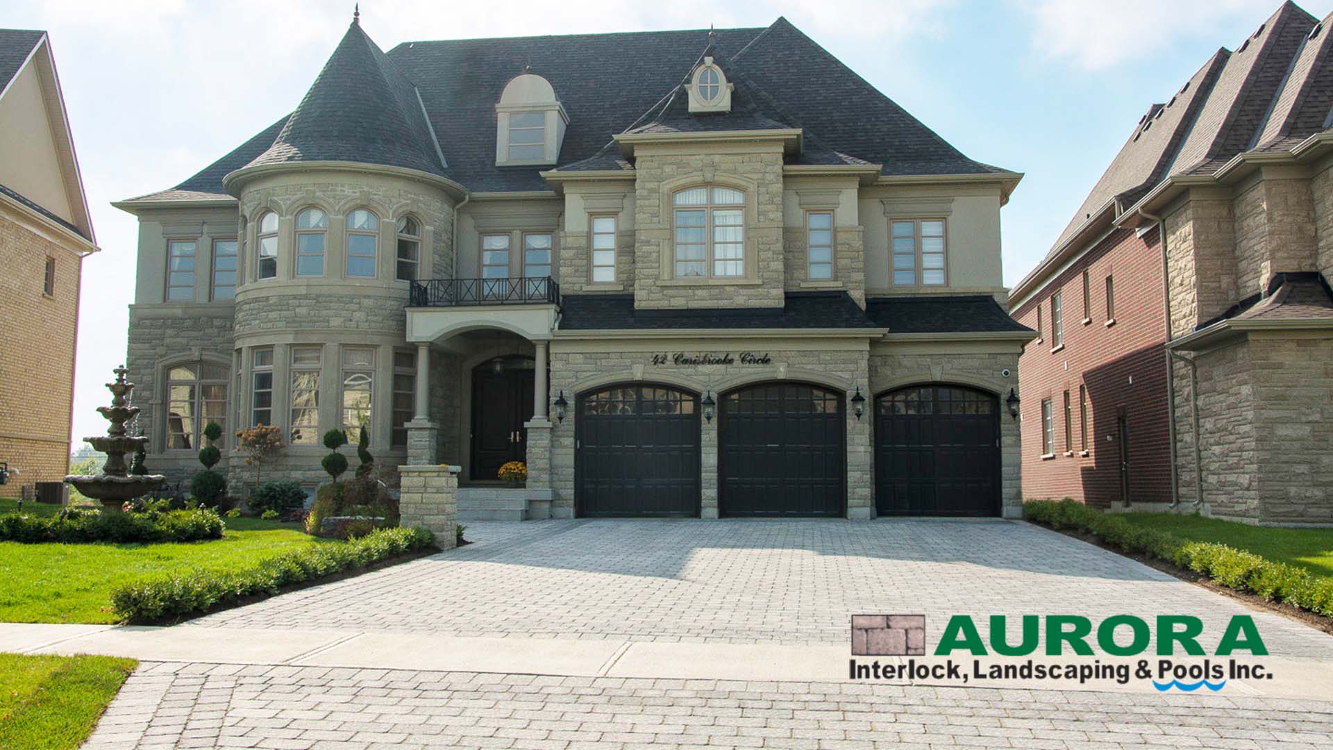 Interlock driveway and front entrance by Aurora Interlock & Pools